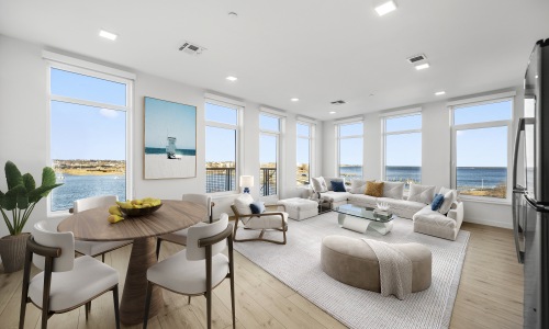 Luxury Waterfront Apartment Interior at Gibson Point | Floor-to-Ceiling Views in Revere, MA Bright, modern apartment at Gibson Point in Revere, MA featuring floor-to-ceiling windows, open-concept living and dining area, and sweeping ocean views